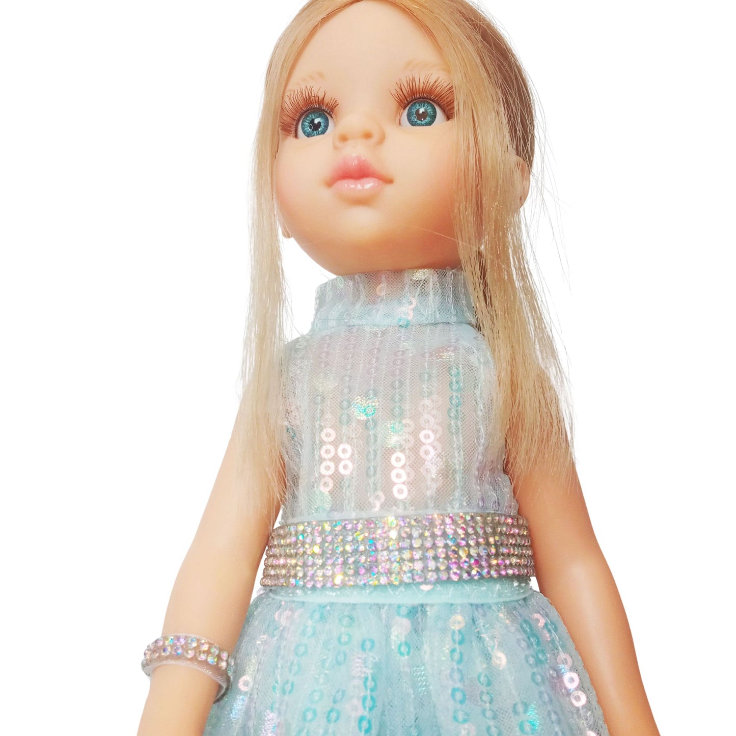 Paola Reina 32 cm doll in a shimmering sequin fairy dress with a sparkling belt and clutch standing on a floor.