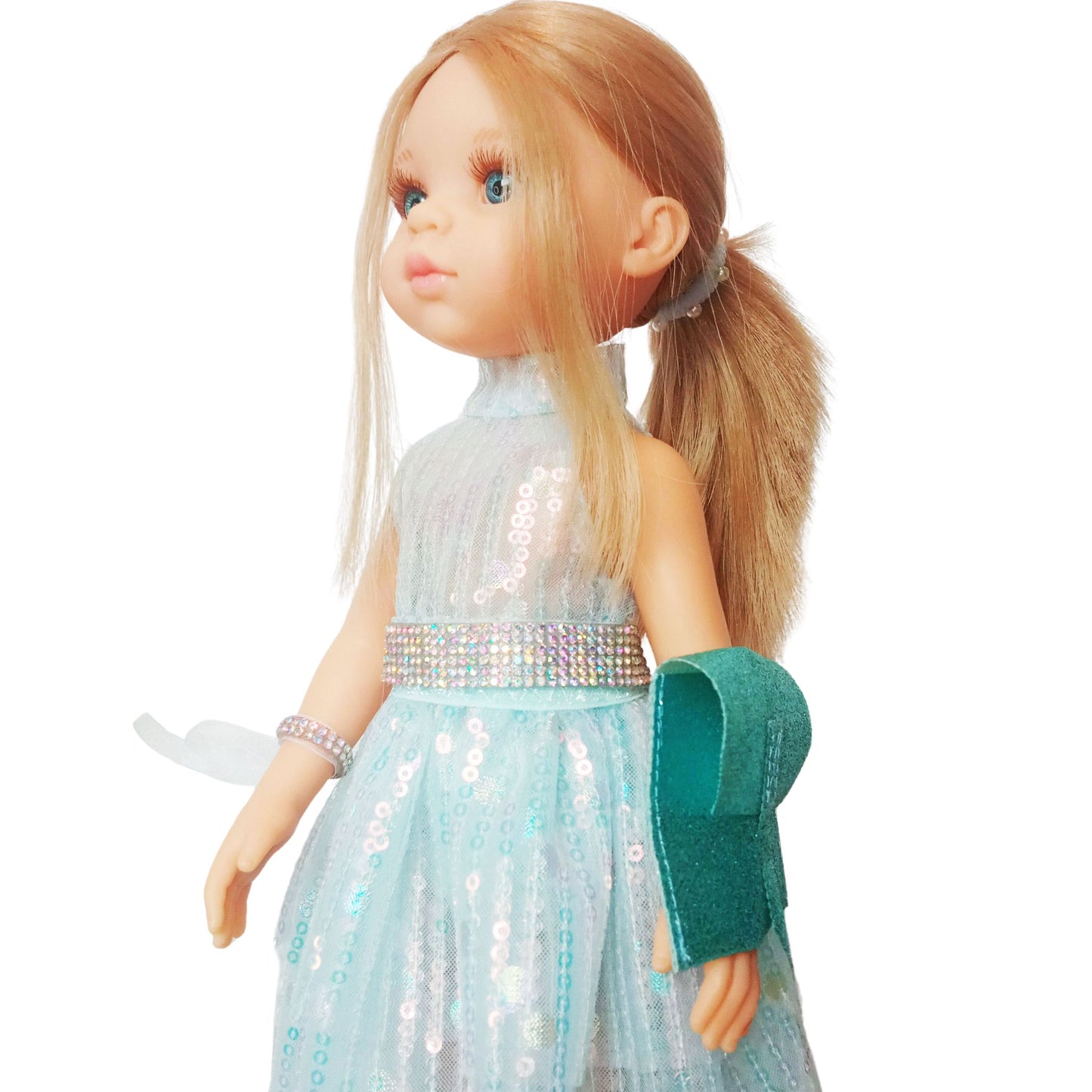 Paola Reina 32 cm doll in a shimmering sequin fairy dress with a sparkling belt and clutch standing on a floor.