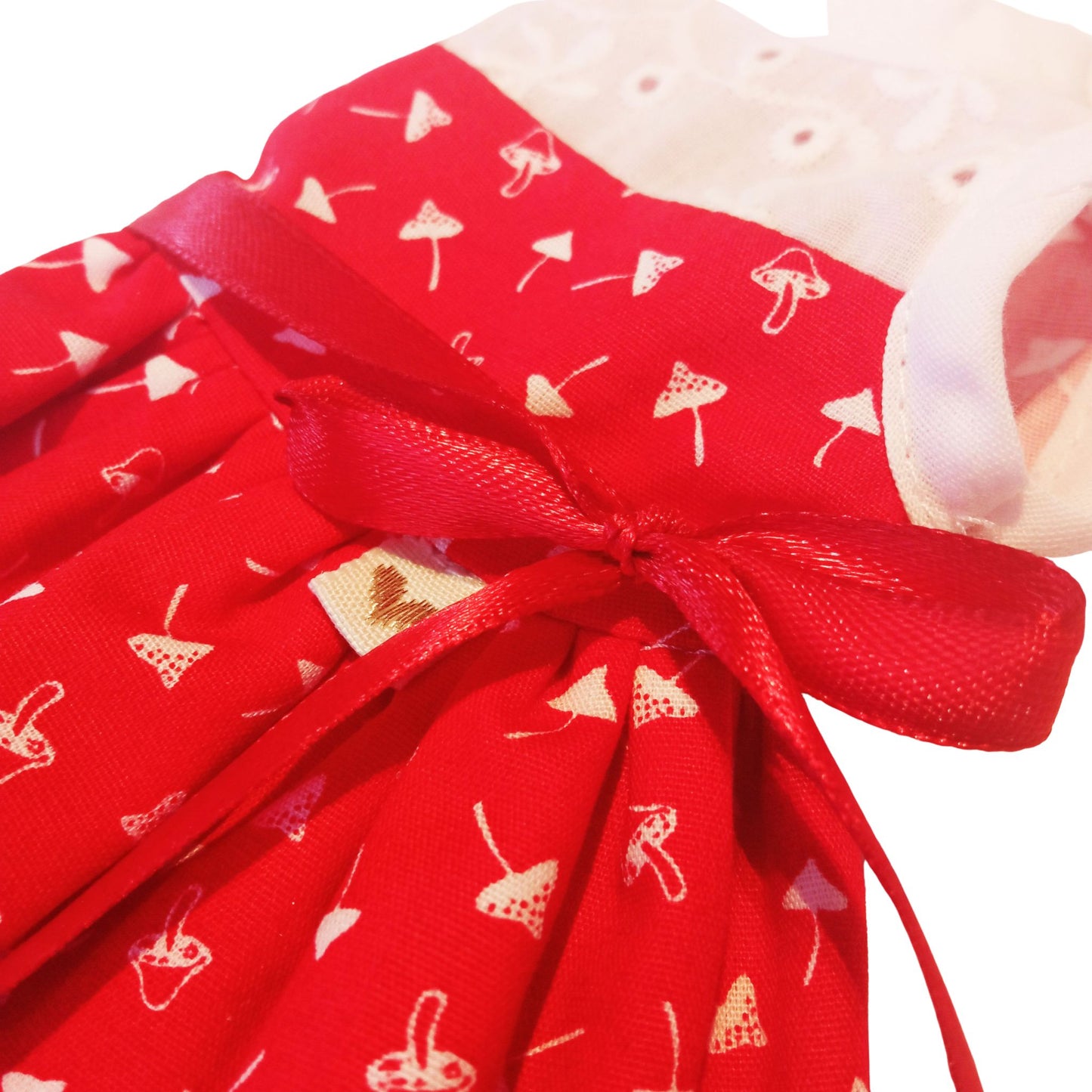 Red and white doll dress with a lace bodice, fly agaric mushroom print, and a satin bow, paired with red lace-up boots, designed for a 32 cm Paola Reina doll.