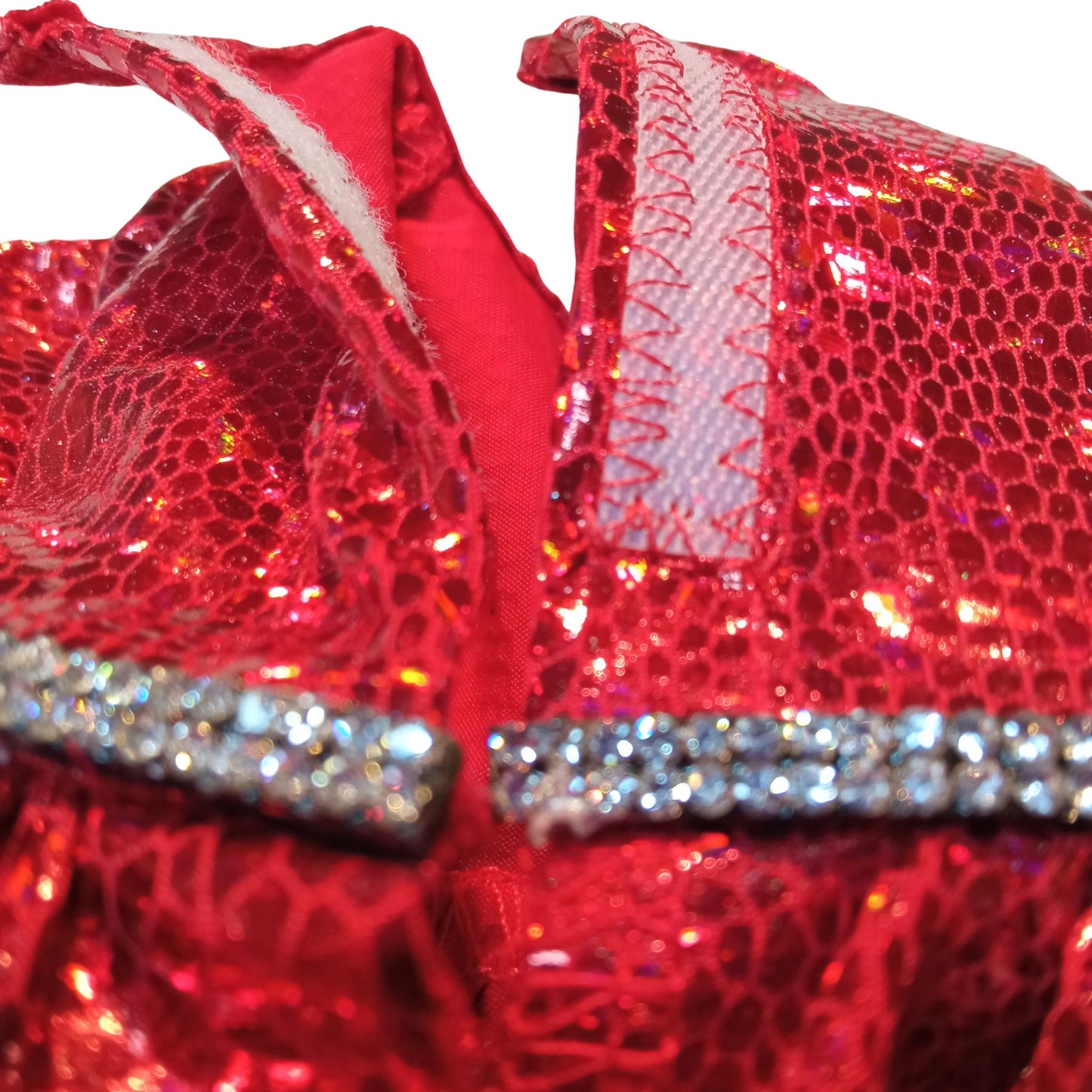 A red sparkling dress with a rhinestone belt and black patent leather shoes, standing against a white background for Paola Reina 32 cm doll.