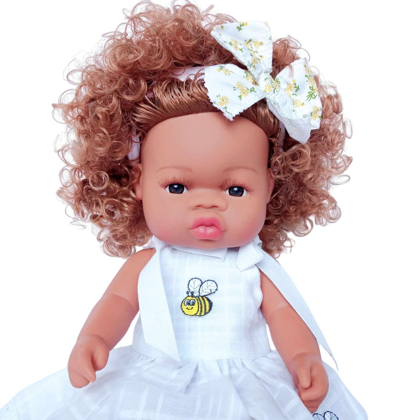 Doll in a white cotton sundress with embroidered bees, lace trim, and tied shoulder straps, accessorized with a matching bow headband, fits 34 cm dolls like Paola Reina or Baby Born