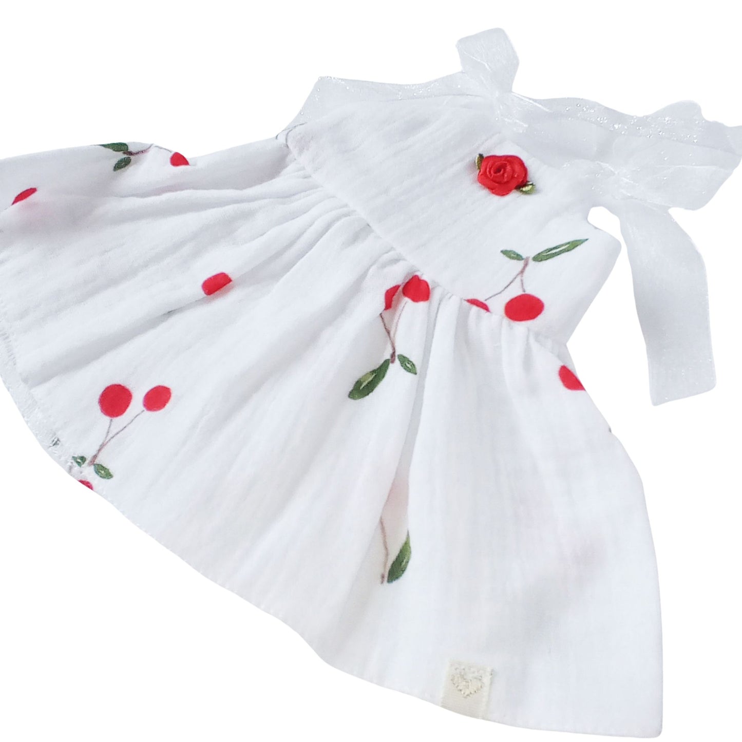A white summer cotton sundress with cherry print and red rose detail, designed for 34 cm dolls like Paola Reina or Baby Born.