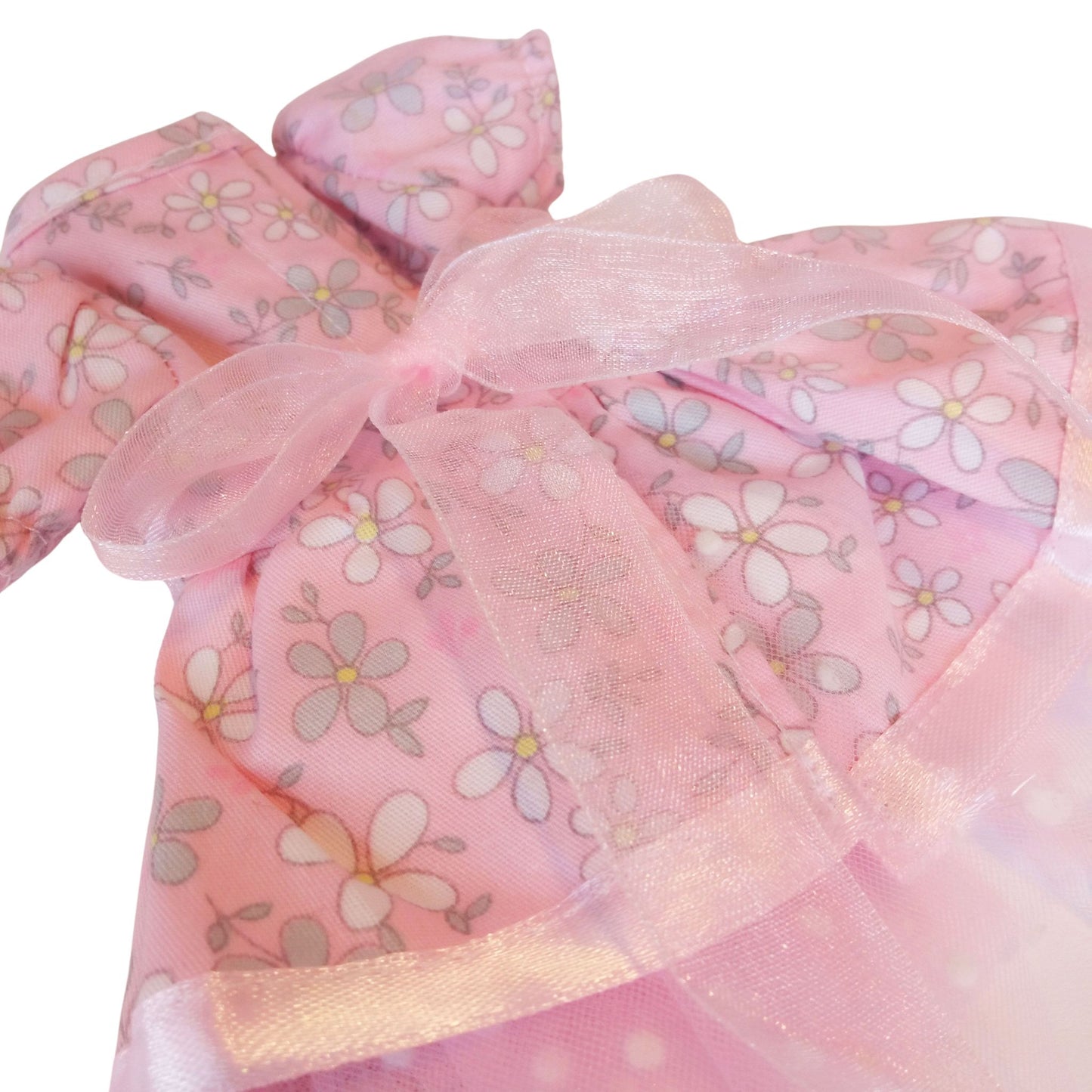 Paola Reina dolls dress wearing pink floral cotton dresses with lace and tulle details.