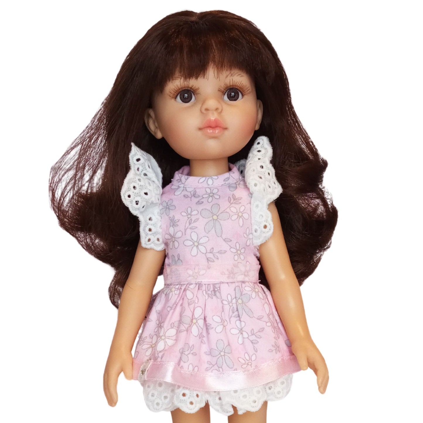 Paola Reina doll wearing pink floral cotton dresses with lace and tulle details.