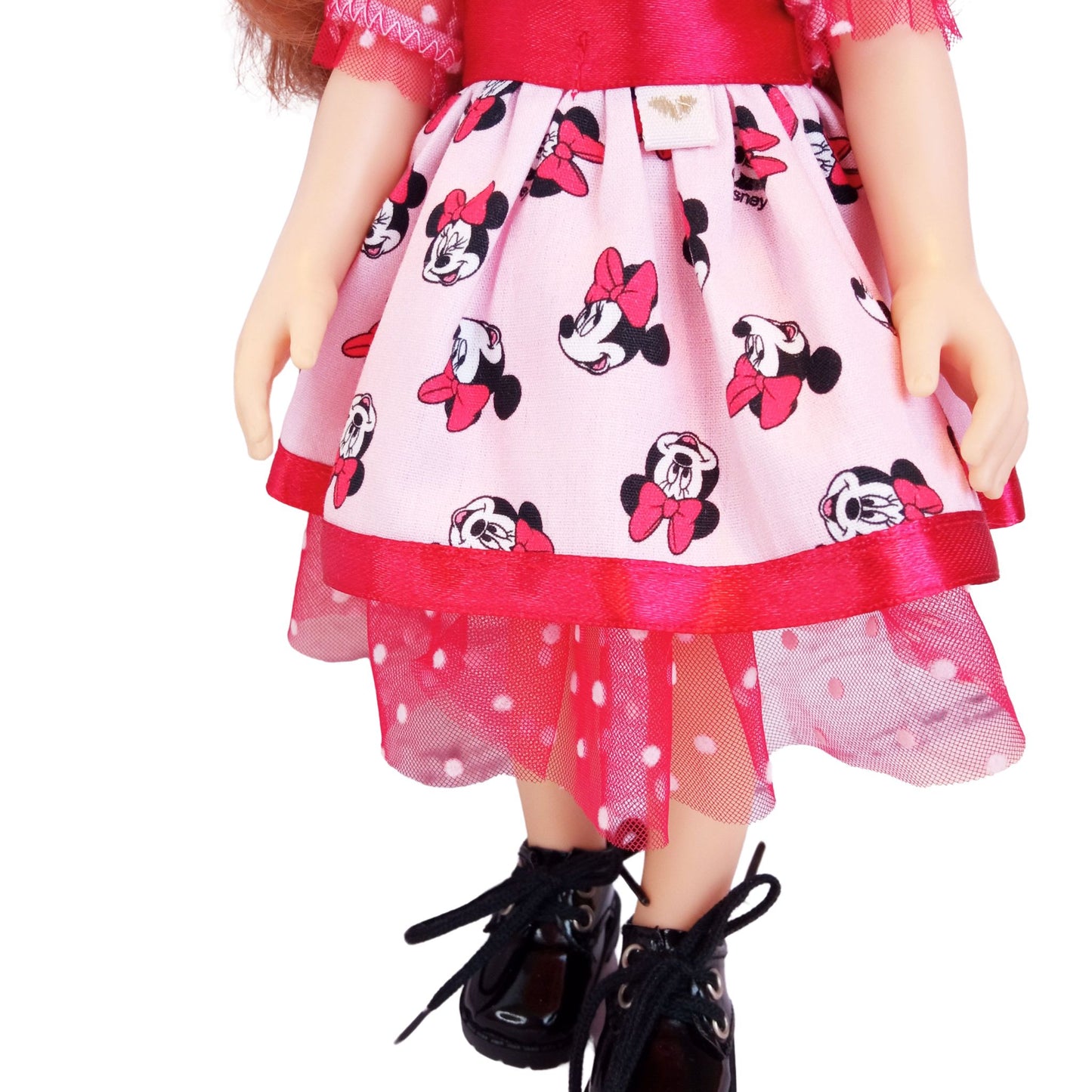 Paola Reina 32 cm doll wearing matching Minnie Mouse-inspired dresses with red satin bows and polka-dot mesh details.