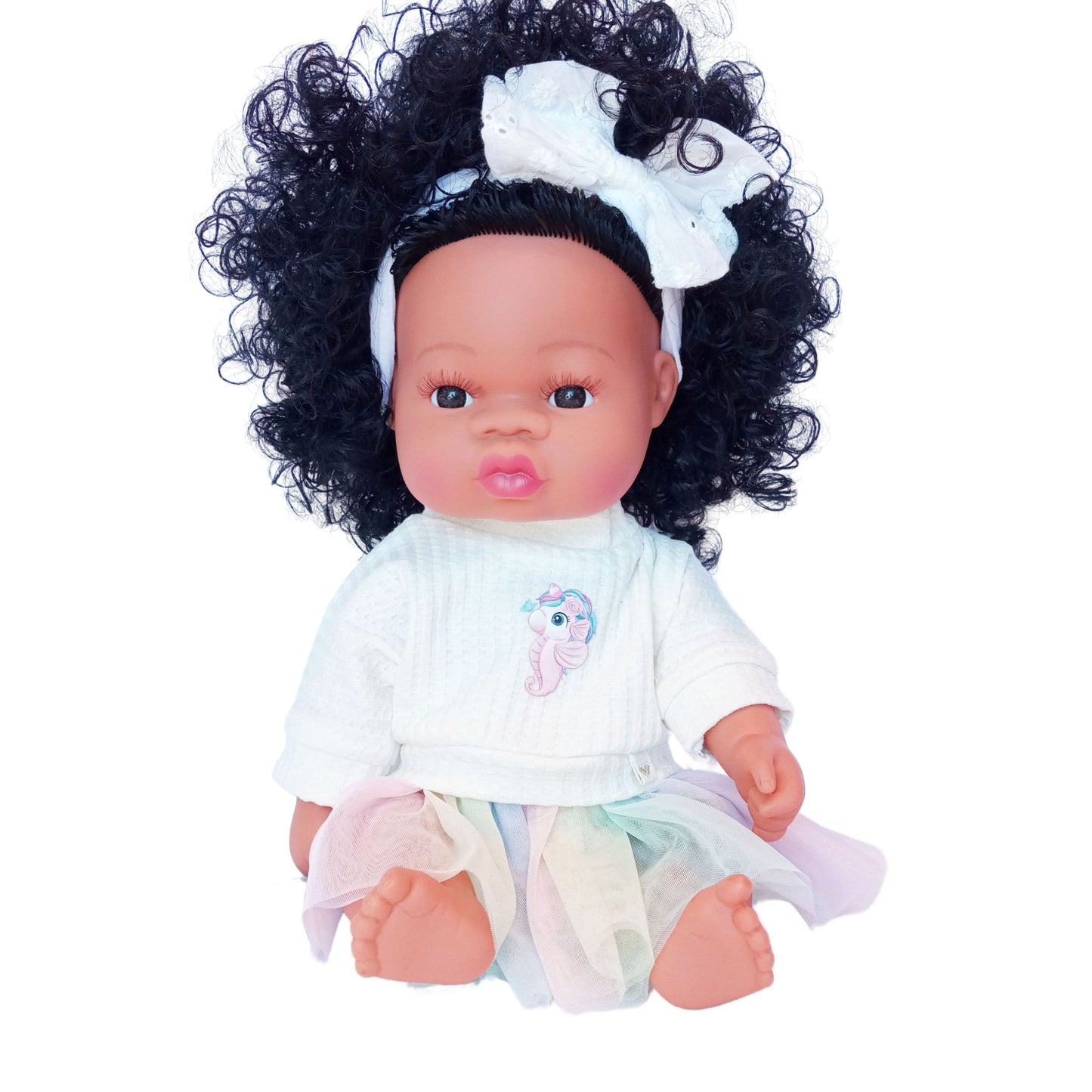 Doll wearing a pastel rainbow skirt and cream knit blouse with unicorn-seahorse print, styled for Paola Reina or Baby Born 34 cm dolls.