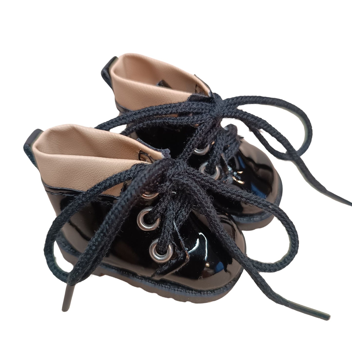 Glossy black lace-up boots with beige cuffs, designed for 32 cm Paola Reina dolls. Featuring black laces, metal eyelets, and a chunky sole for a bold fashion statement