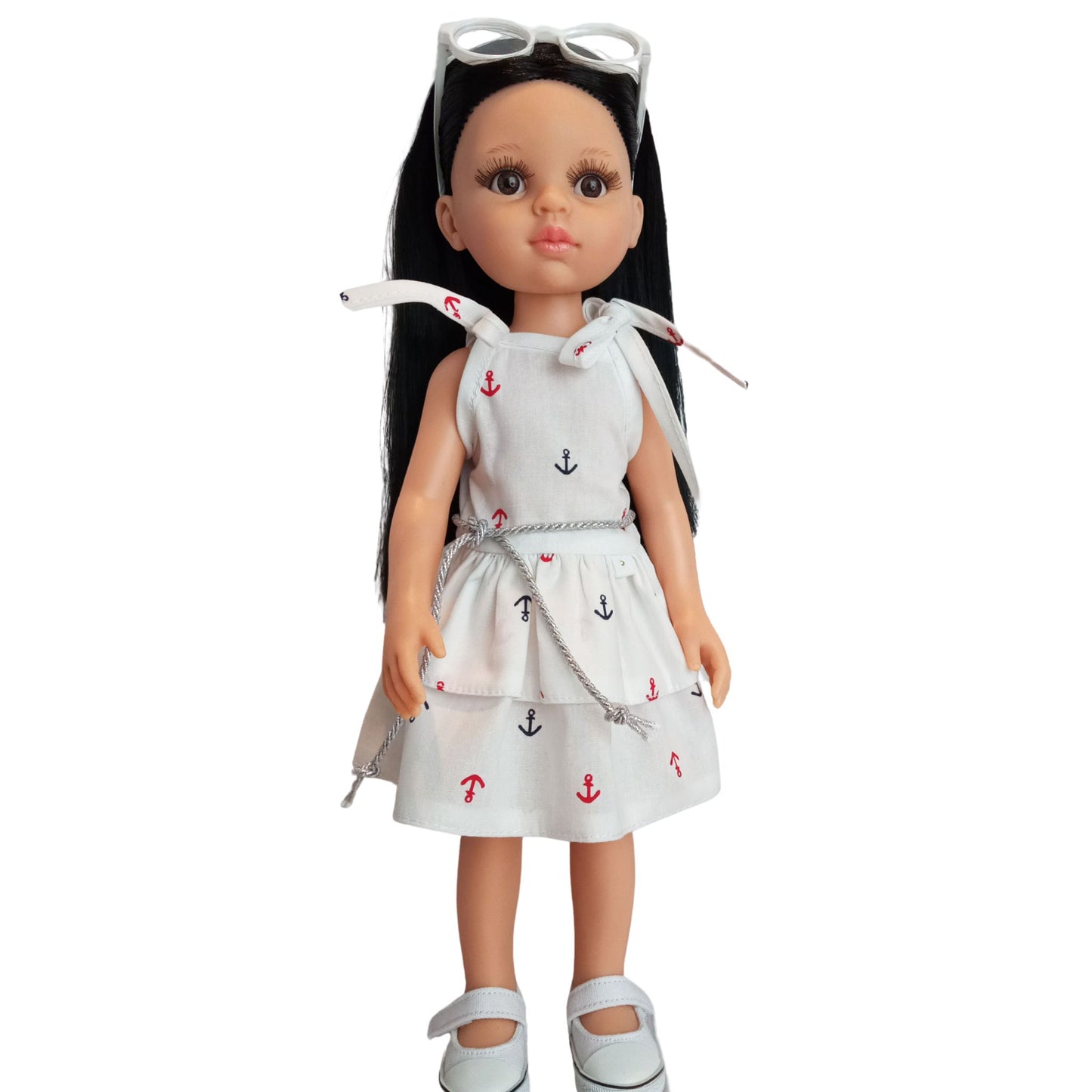 Paola Reina 32 cm doll wearing a white nautical dress with anchor prints, a silver belt, and stylish white sunglasses.