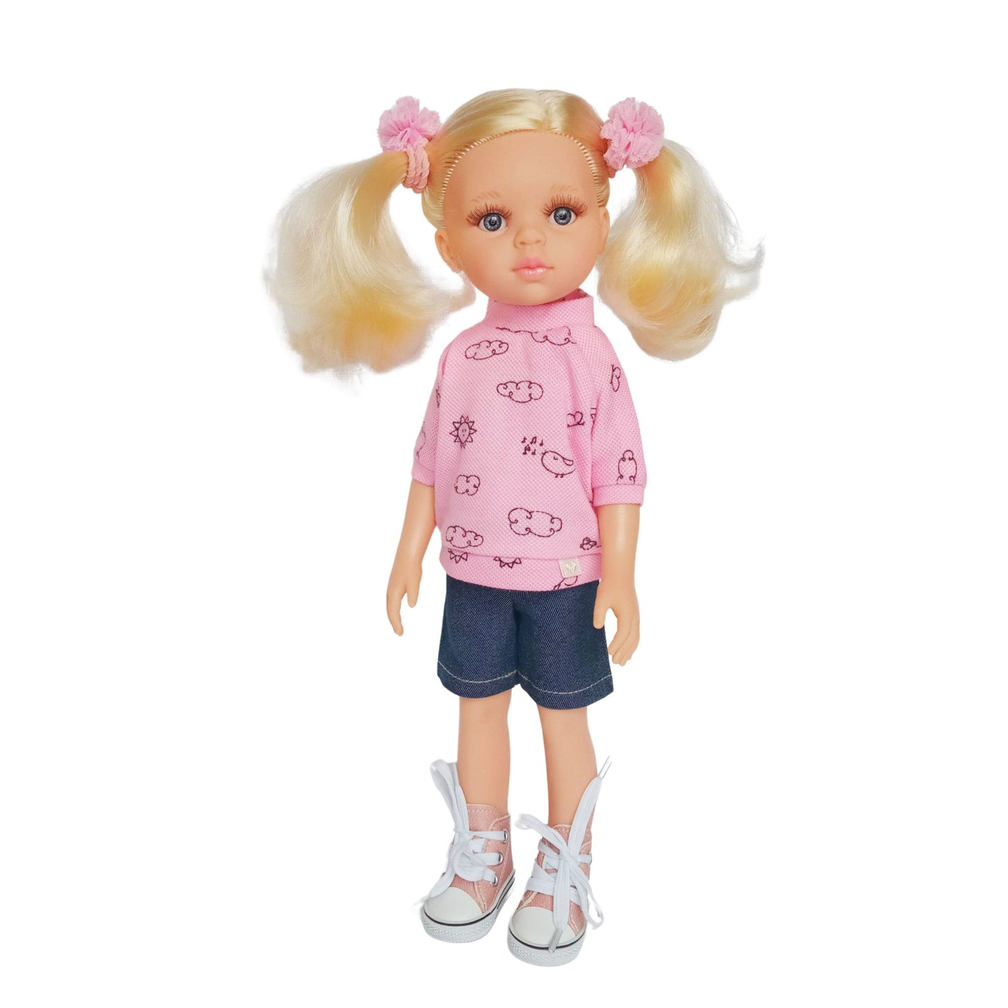 Paola Reina 32 cm dolls wearing pink blouses with cloud prints, one styled with denim pants and the other with denim shorts and sneakers.