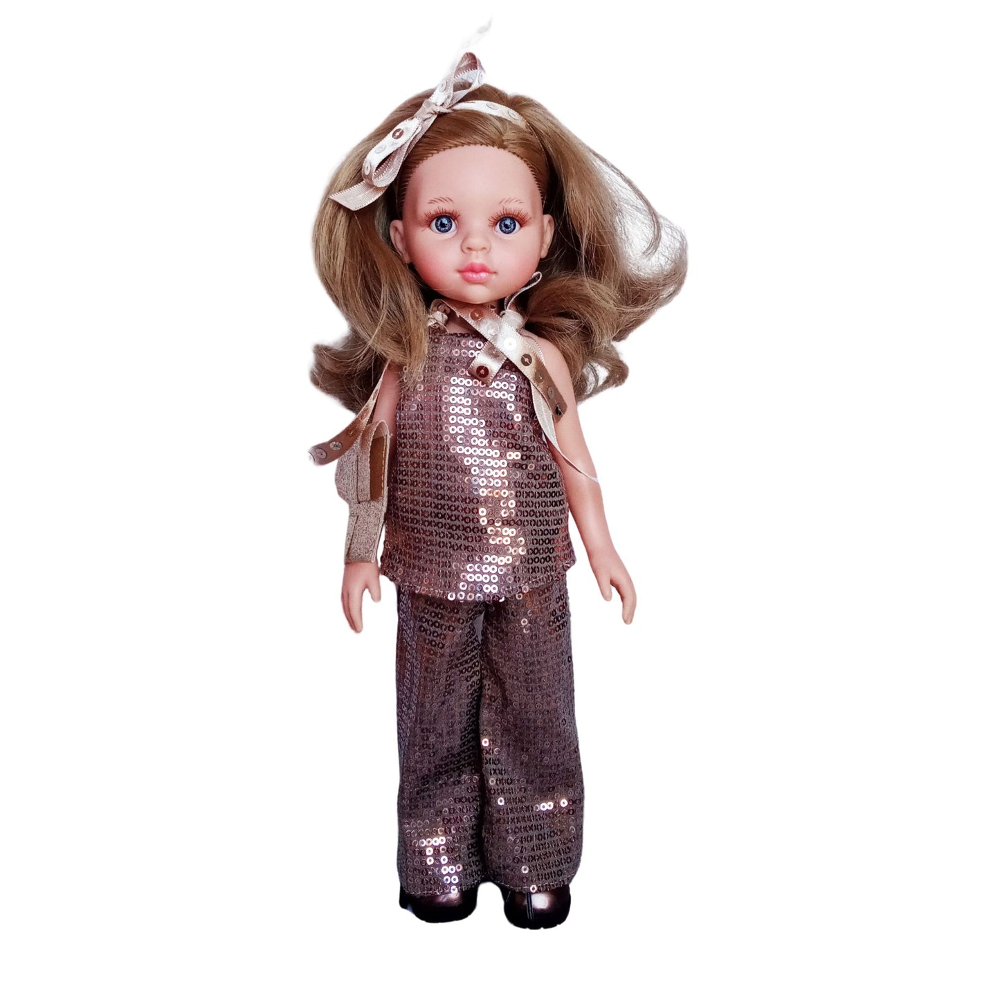 Paola Reina Carla 32 cm doll in a sparkling bronze sequin outfit with a clutch, ribbon accessories, and bronze patent leather shoes, standing against a white background.