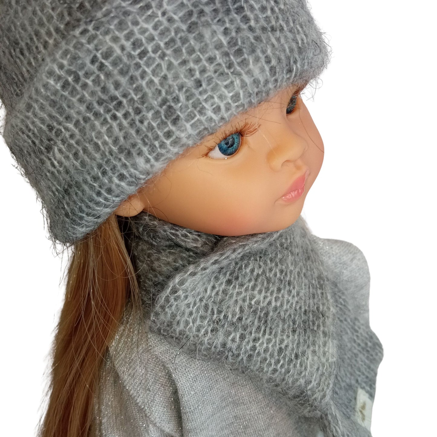 Paola Reina 32 cm doll wearing a soft gray knitted hat with a tiny star detail and a matching scarf, dressed in a cozy outfit.