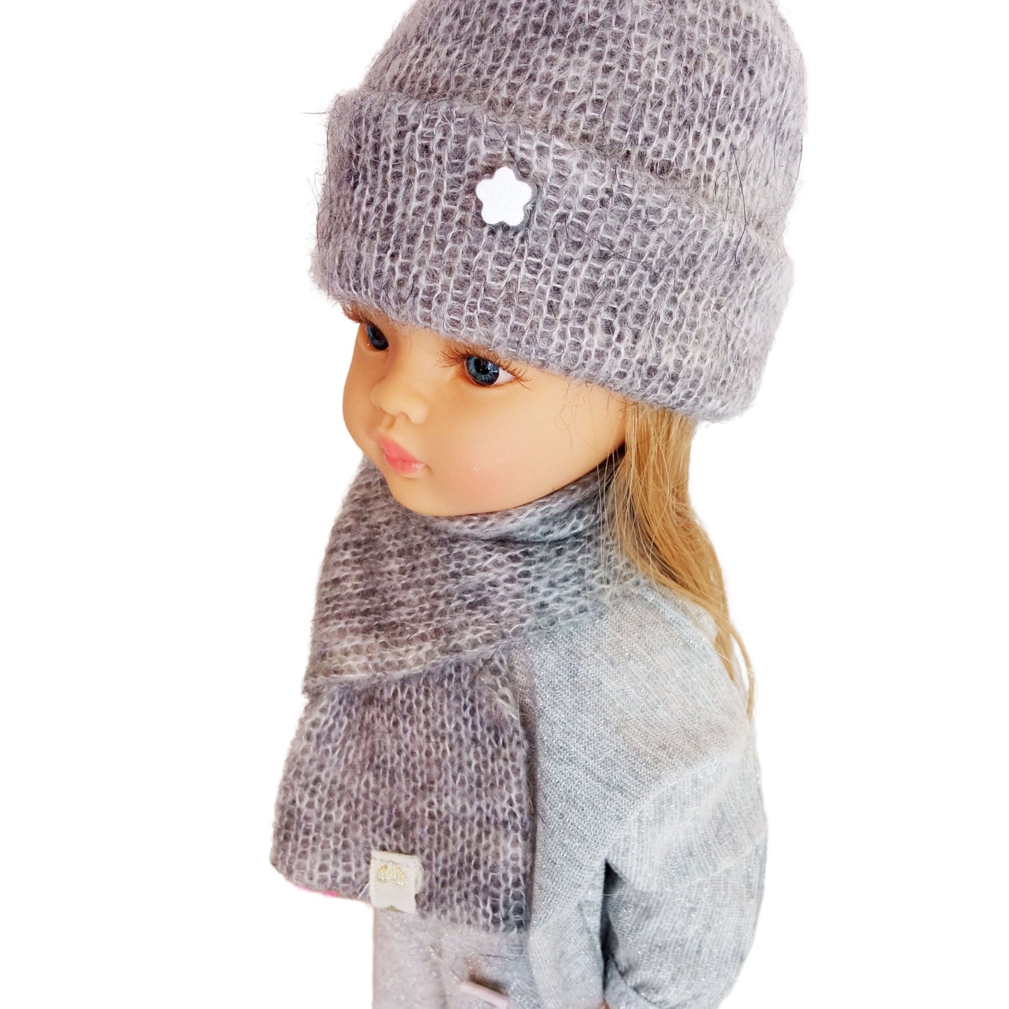 Paola Reina 32 cm doll wearing a soft gray knitted hat with a tiny star detail and a matching scarf, dressed in a cozy outfit.