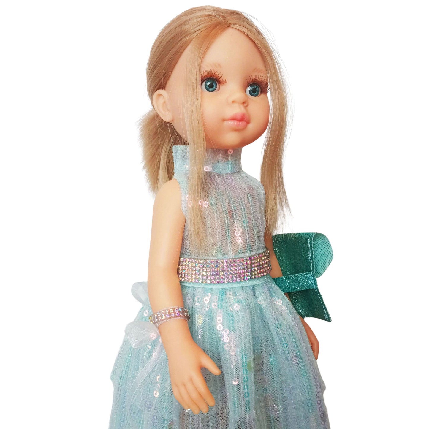 Paola Reina 32 cm doll in a shimmering sequin fairy dress with a sparkling belt and clutch standing on a floor.