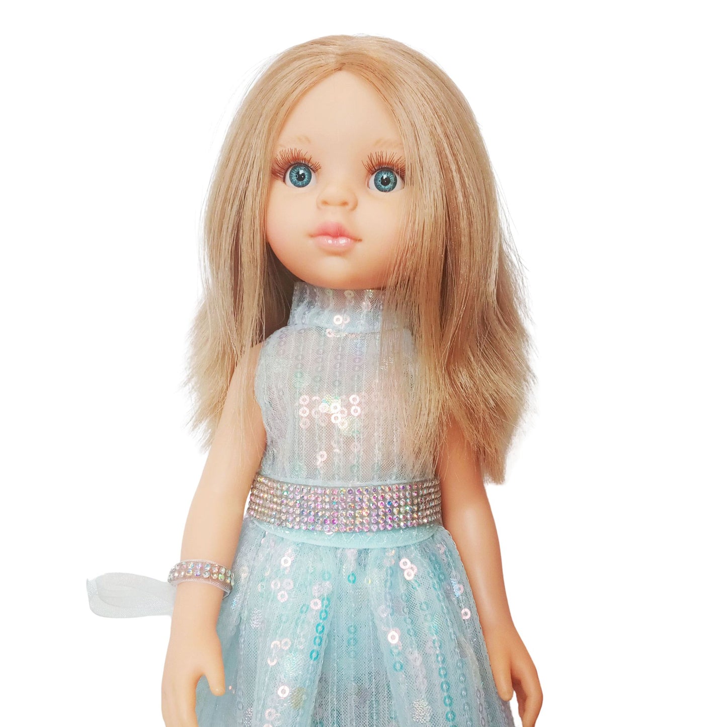 Paola Reina 32 cm doll in a shimmering sequin fairy dress with a sparkling belt and clutch standing on a floor.