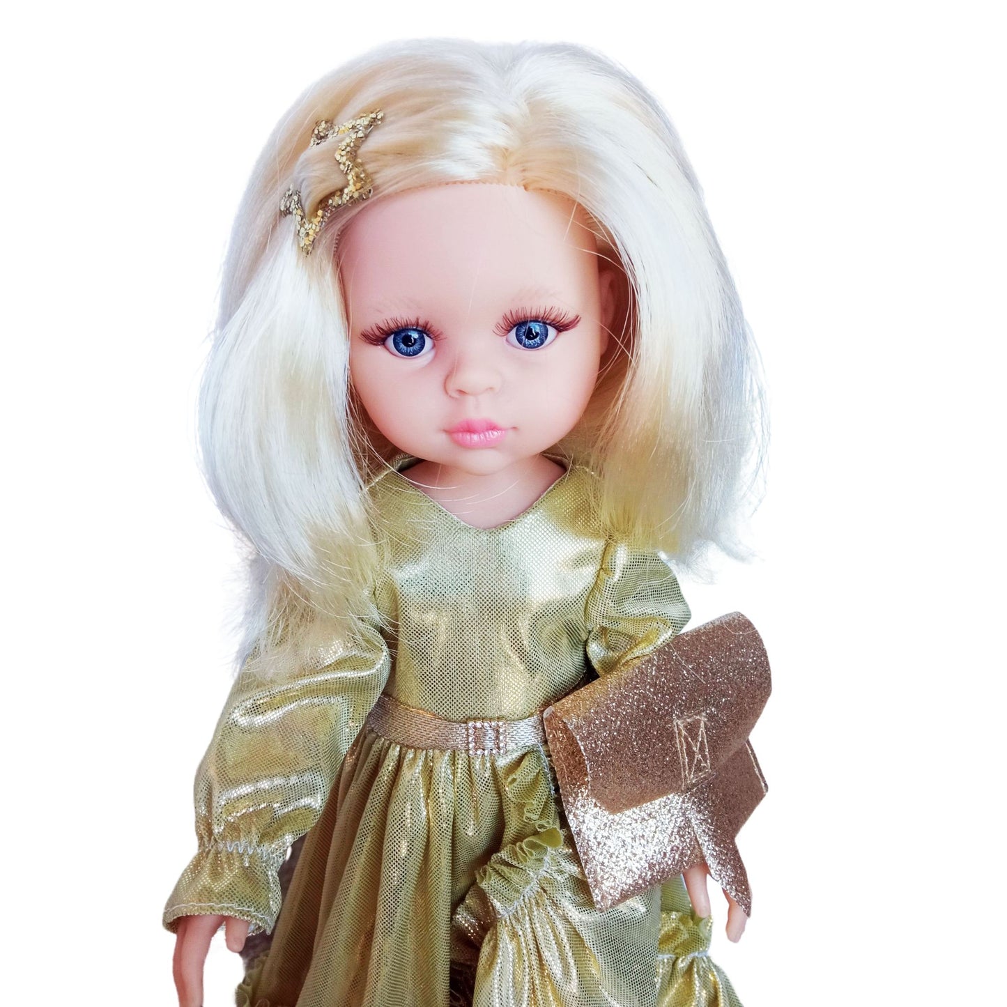 Paola Reina 32 cm doll Claudia dressed in an elegant shimmering gold gown with ruffles, holding a glittery clutch, and wearing stylish gold-trimmed shoes.