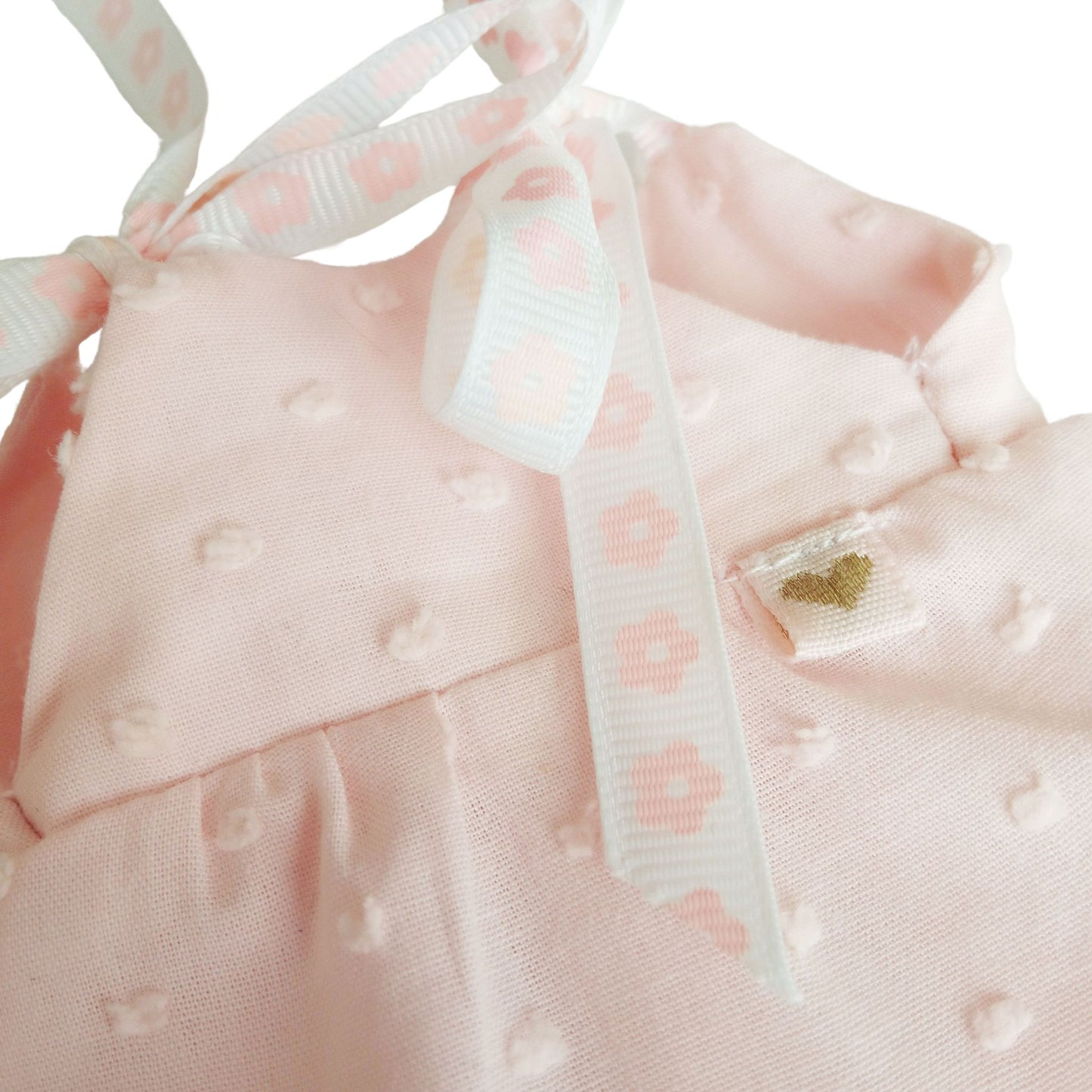 Soft pink sleeveless dress with lace trim perfect for playful adventures and tea parties.