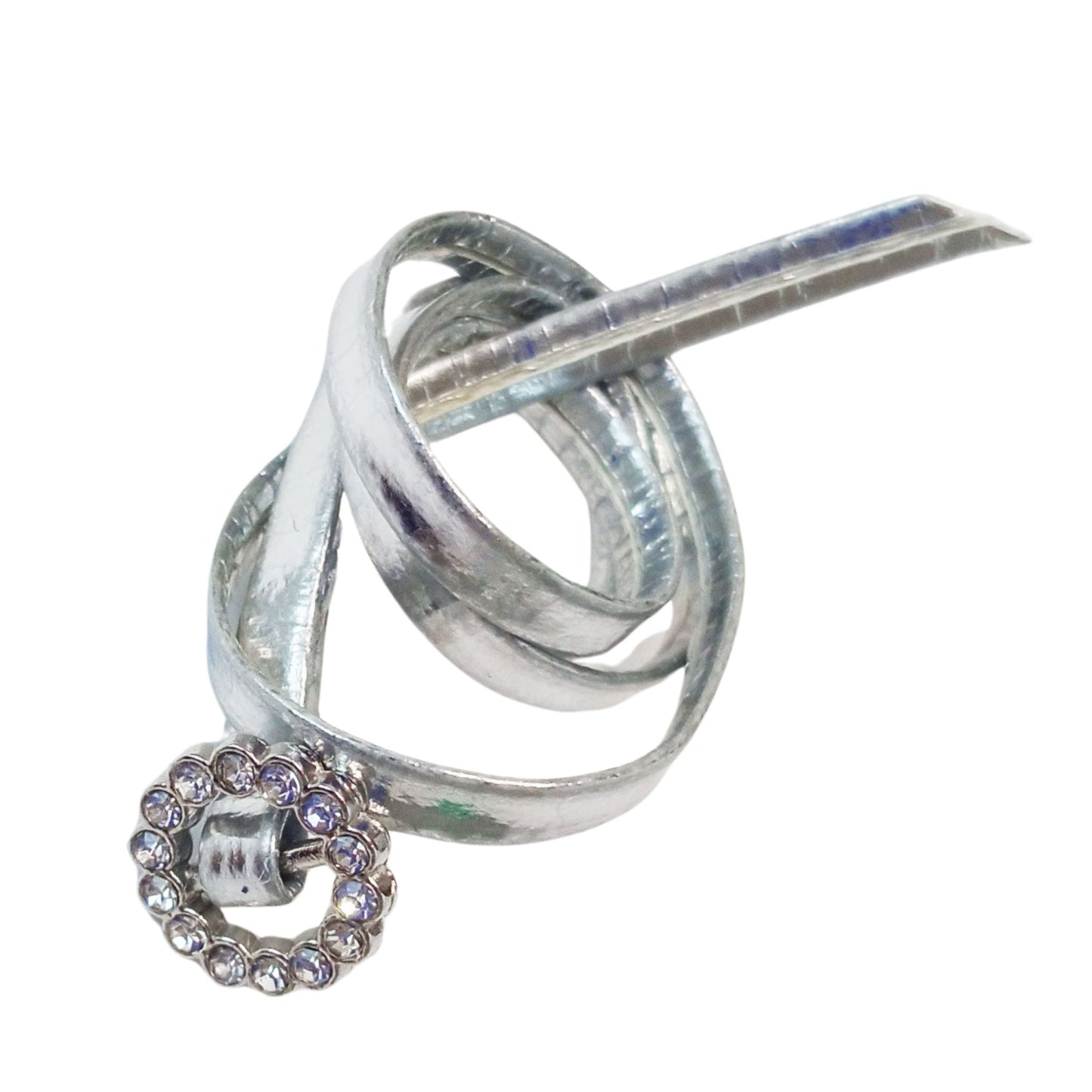 A silver doll belt with a sparkling rhinestone buckle, designed for Paola Reina 32 cm (12-inch) dolls, stylishly coiled in a playful knot.