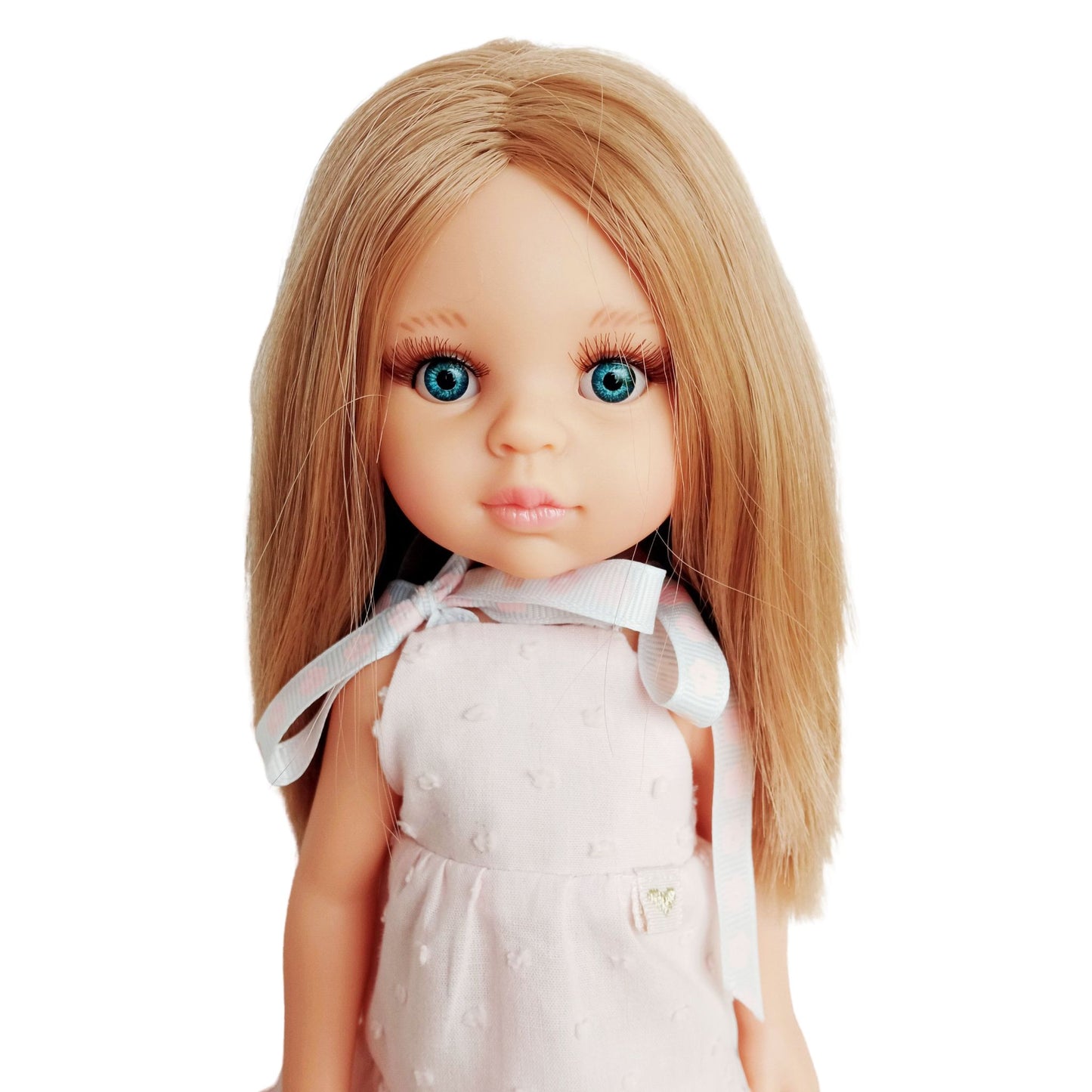 Blonde doll wearing a soft pink sleeveless dress with lace trim and matching pink boots, perfect for playful adventures and tea parties.