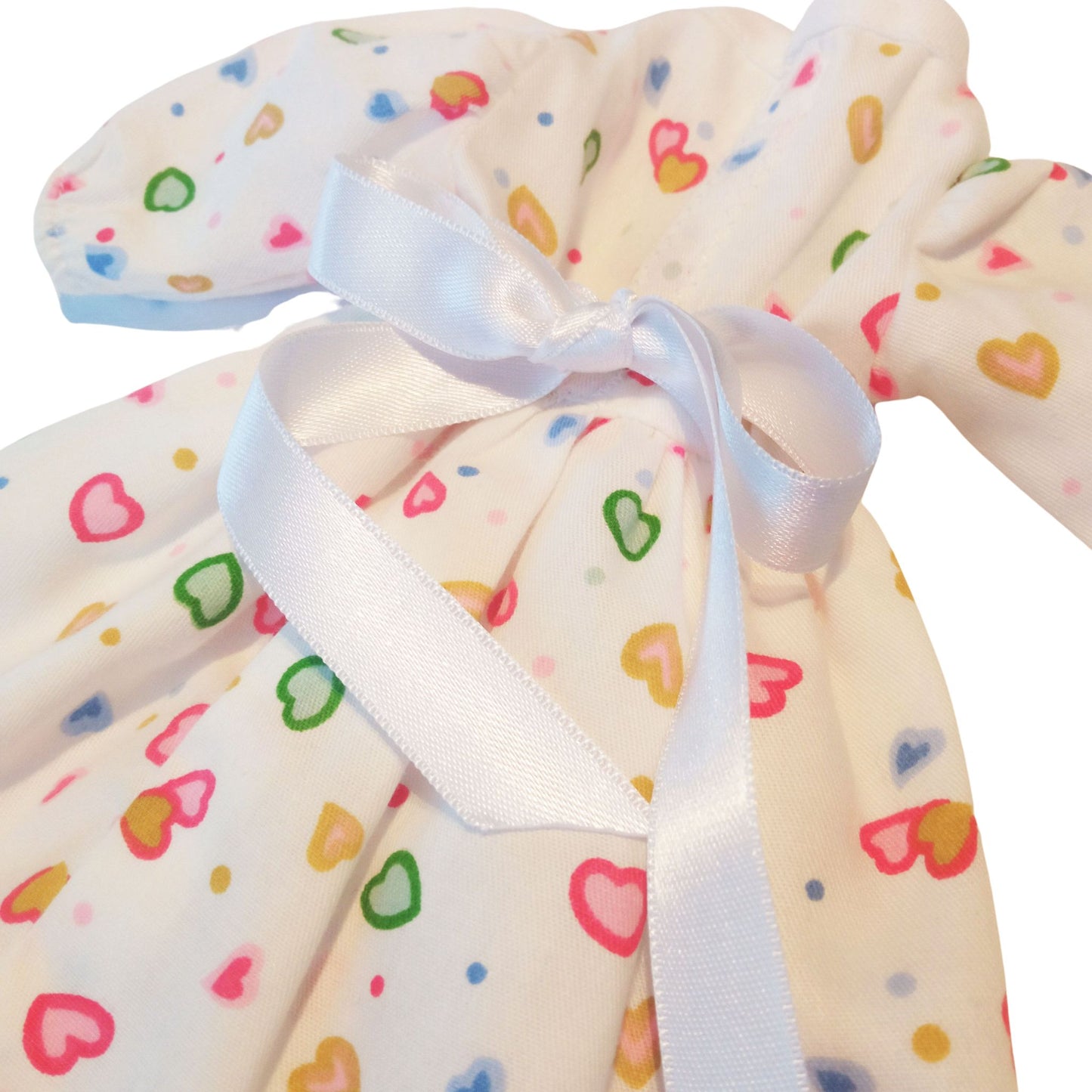 Adorable white dress with colorful heart prints and a satin bow, designed for Paola Reina 32 cm dolls.