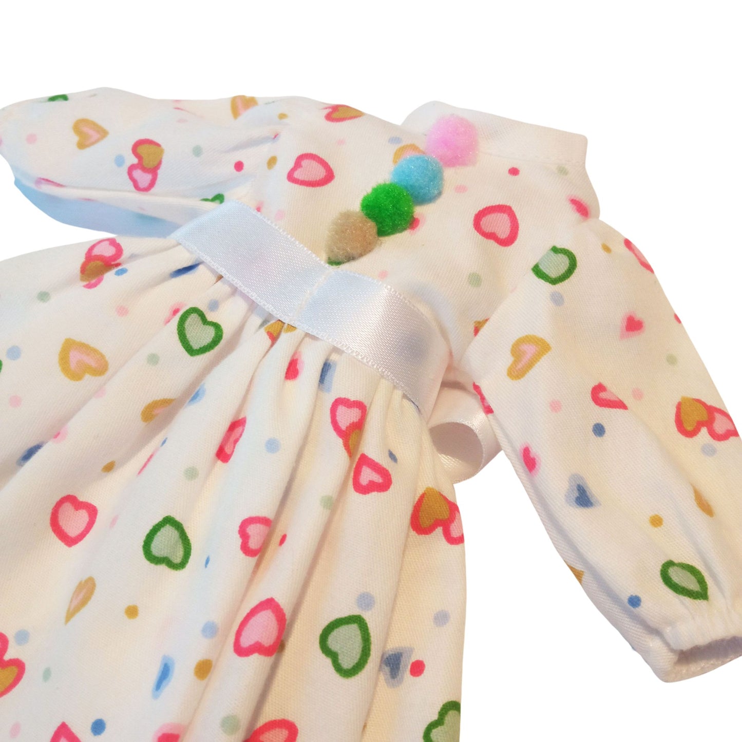 Adorable white dress with colorful heart prints and a satin bow, designed for Paola Reina 32 cm dolls.