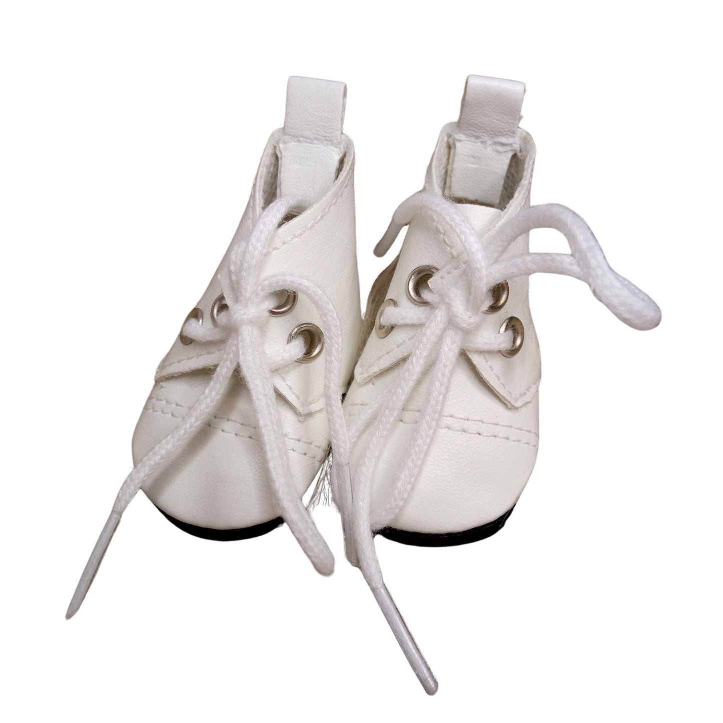 A pair of white lace-up boots for dolls, featuring silver eyelets and black soles, perfect for adding stylish charm to any doll outfit.