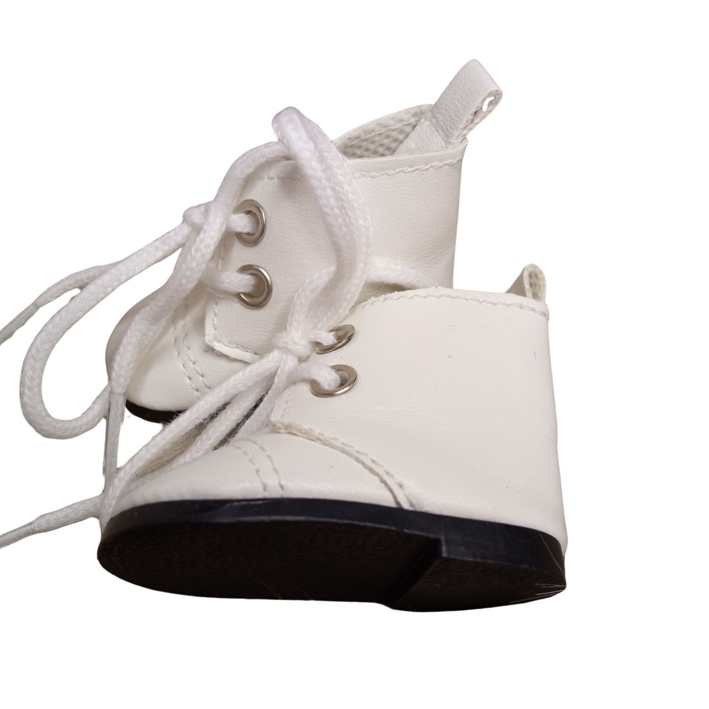 A pair of white lace-up boots for dolls, featuring silver eyelets and black soles, perfect for adding stylish charm to any doll outfit.