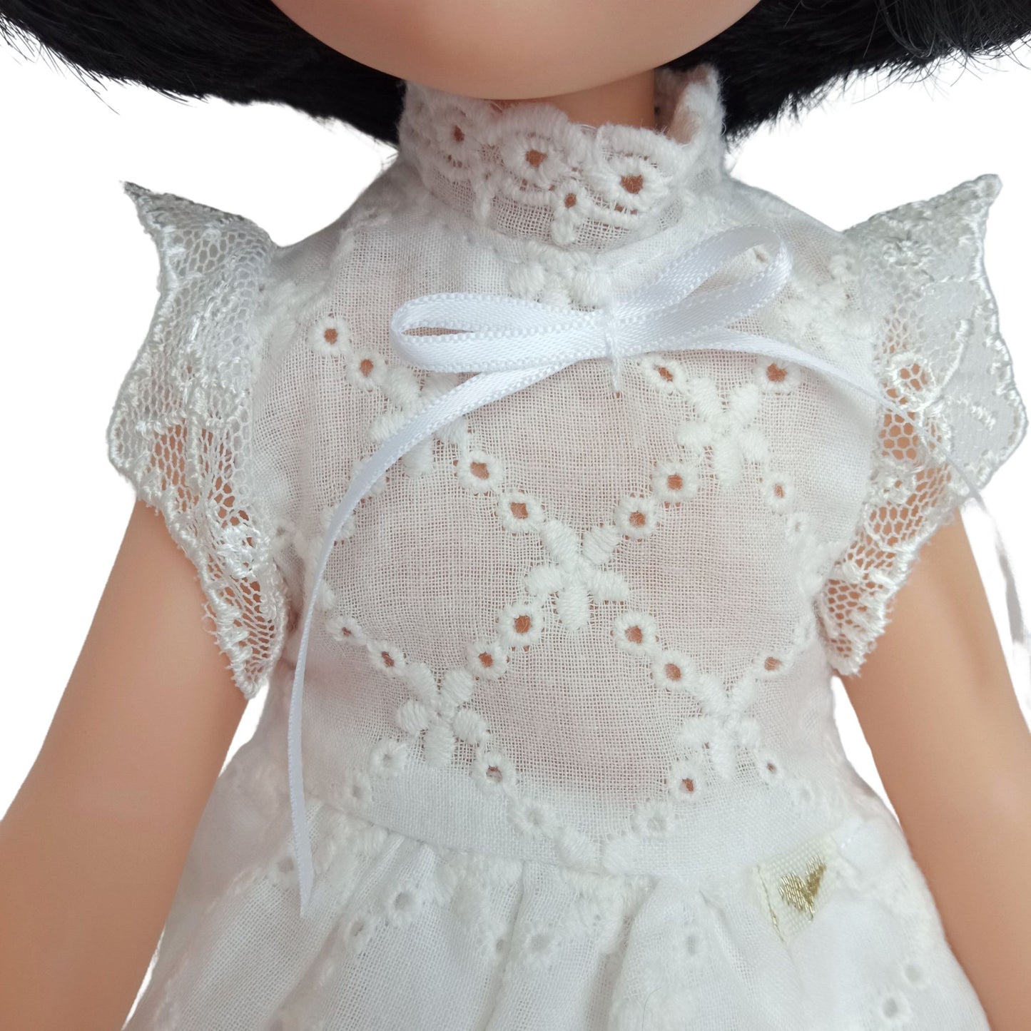 Handmade white lace dress for dolls with short black hair, featuring intricate lace details.
