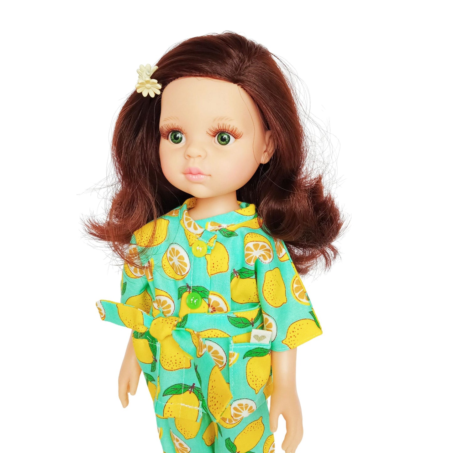 Paola Reina 32 cm doll wearing a bright lemon-printed jumpsuit with a matching belt, standing in yellow boots, styled for a cheerful summer look.