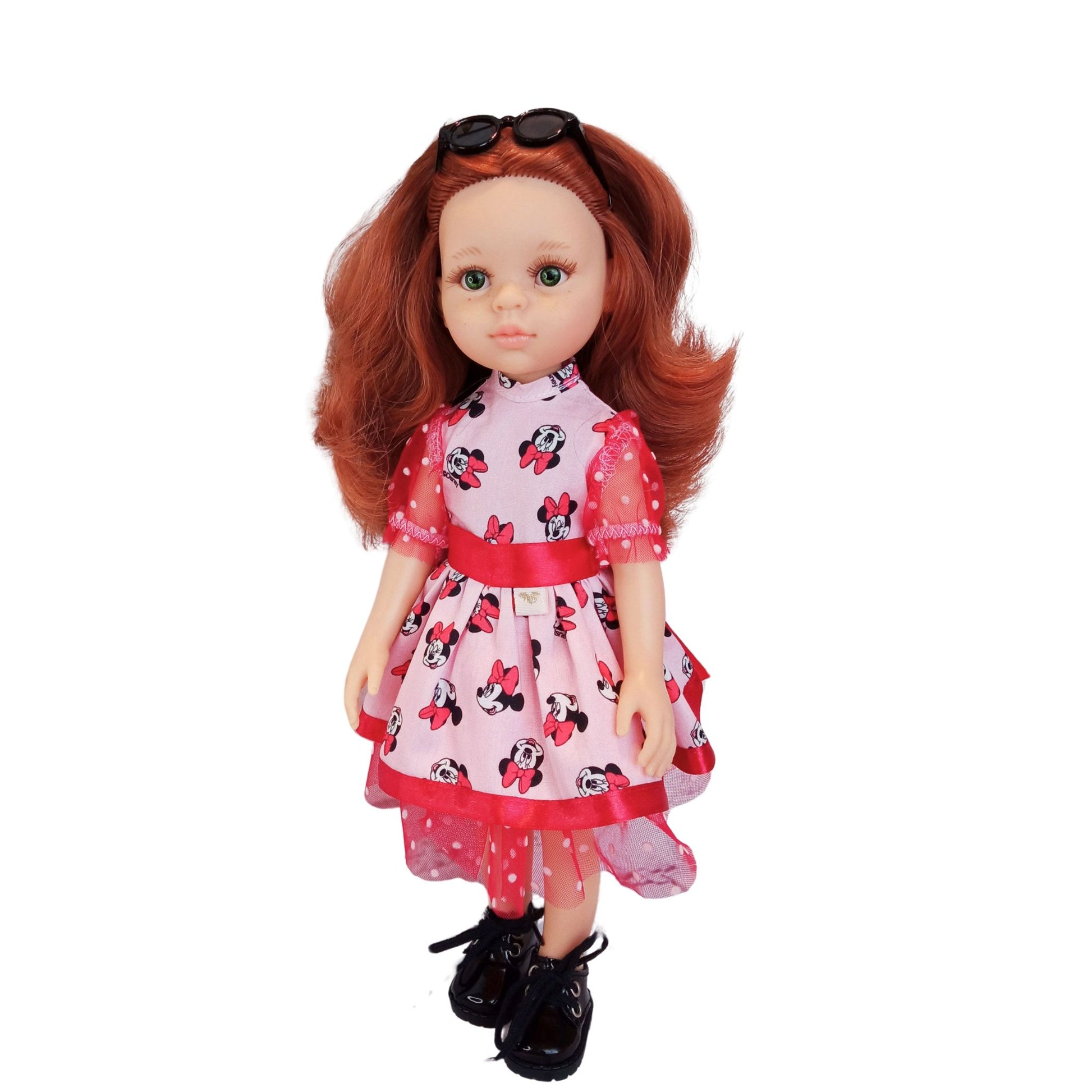 Paola Reina 32 cm doll wearing matching Minnie Mouse-inspired dresses with red satin bows and polka-dot mesh details. One doll has black shoes.