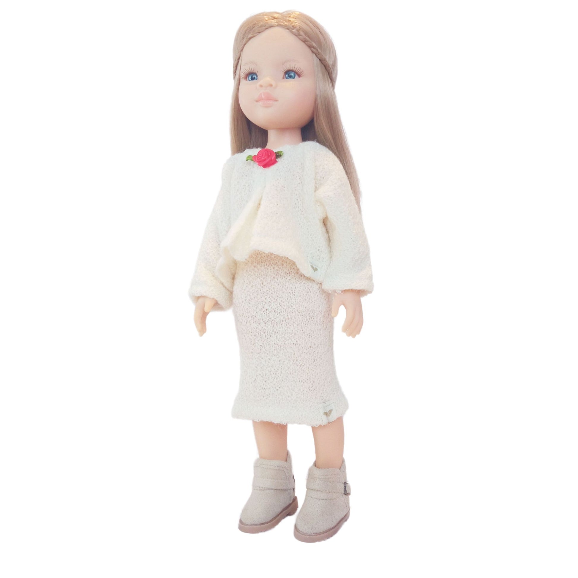 Paola Reina Las Amigas 32 cm dollswearing handmade knitted jersey outfits with floral accents.