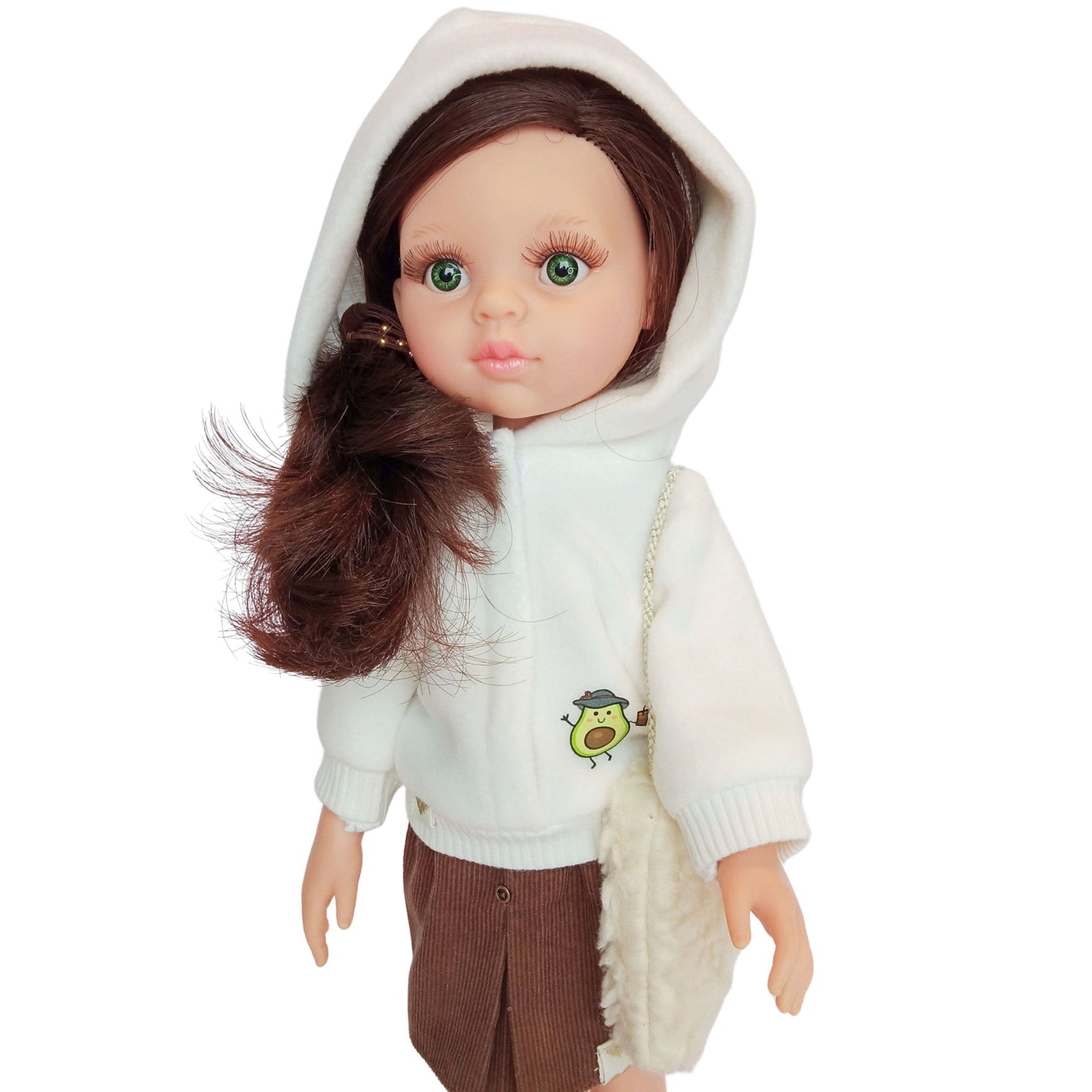 Paola Reina doll wearing white hoodies with an avocado print, paired with brown skirt, styled with boots and accessories.