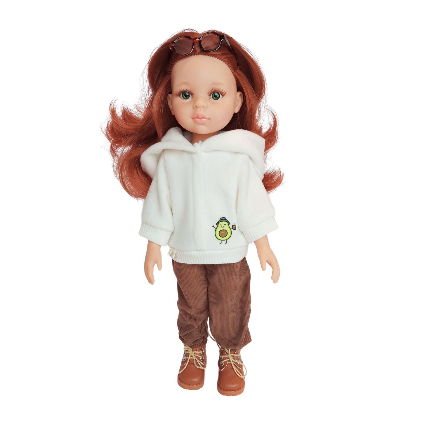 Paola Reina doll wearing white hoodies with an avocado print, paired with brown corduroy pants, styled with boots and accessories.