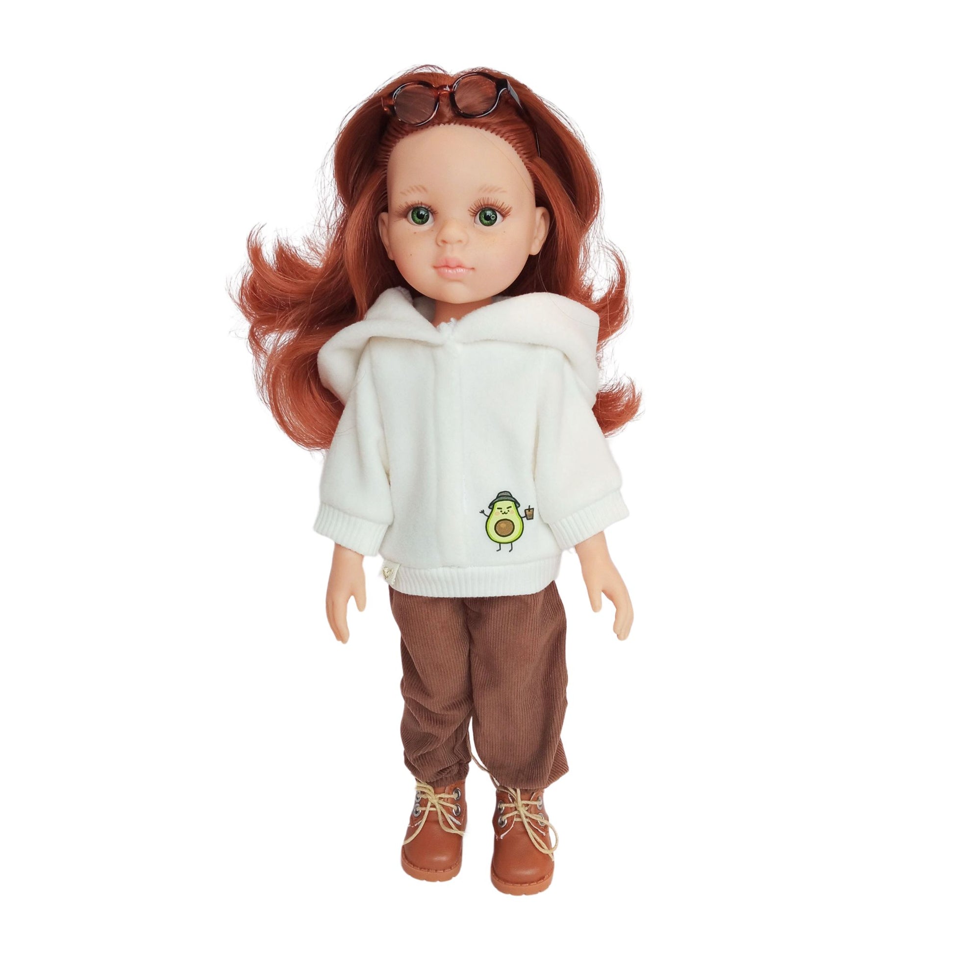 Paola Reina doll wearing white hoodies with an avocado print, paired with brown corduroy pants, styled with boots and accessories.