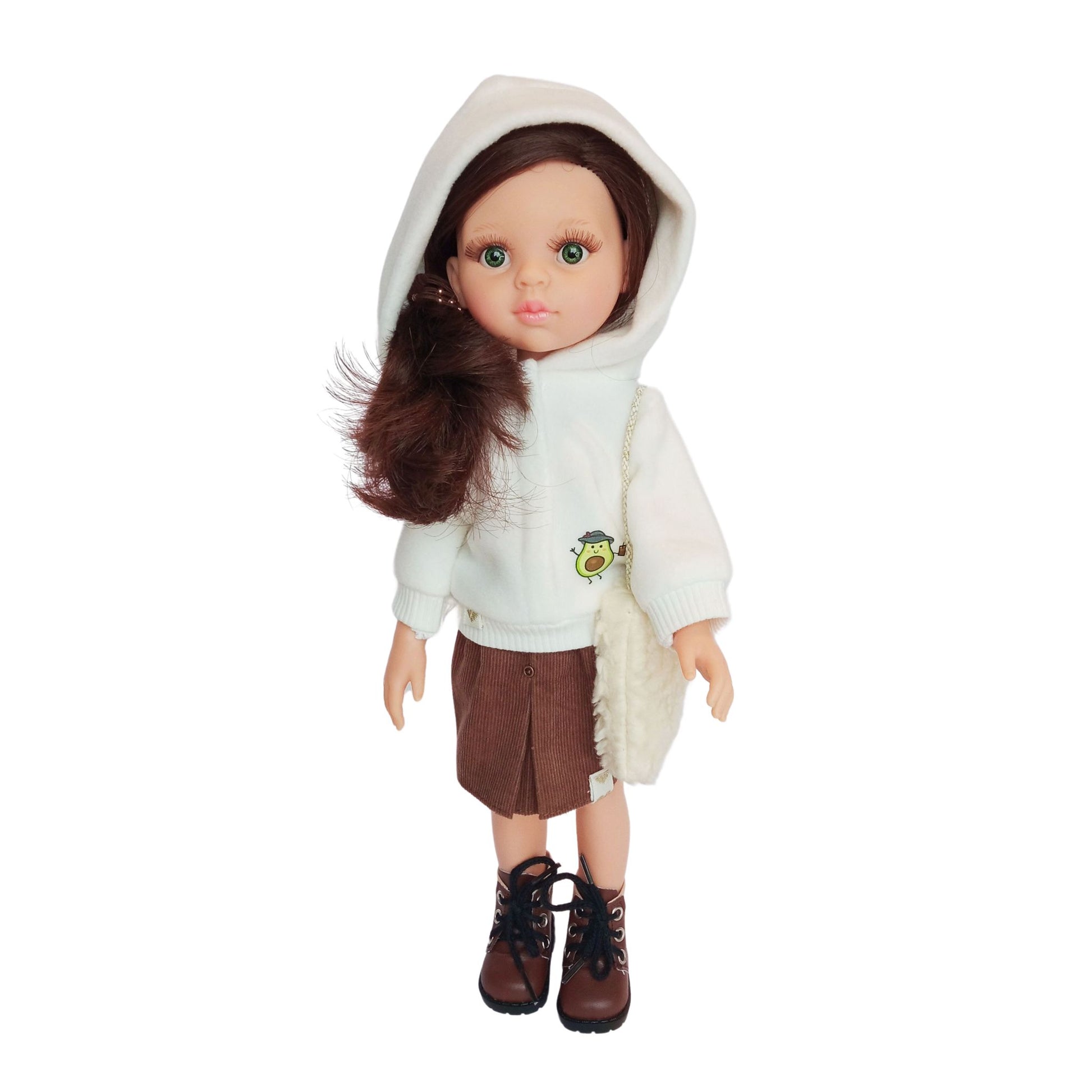 Paola Reina doll wearing white hoodies with an avocado print, paired with brown skirt, styled with boots and accessories.