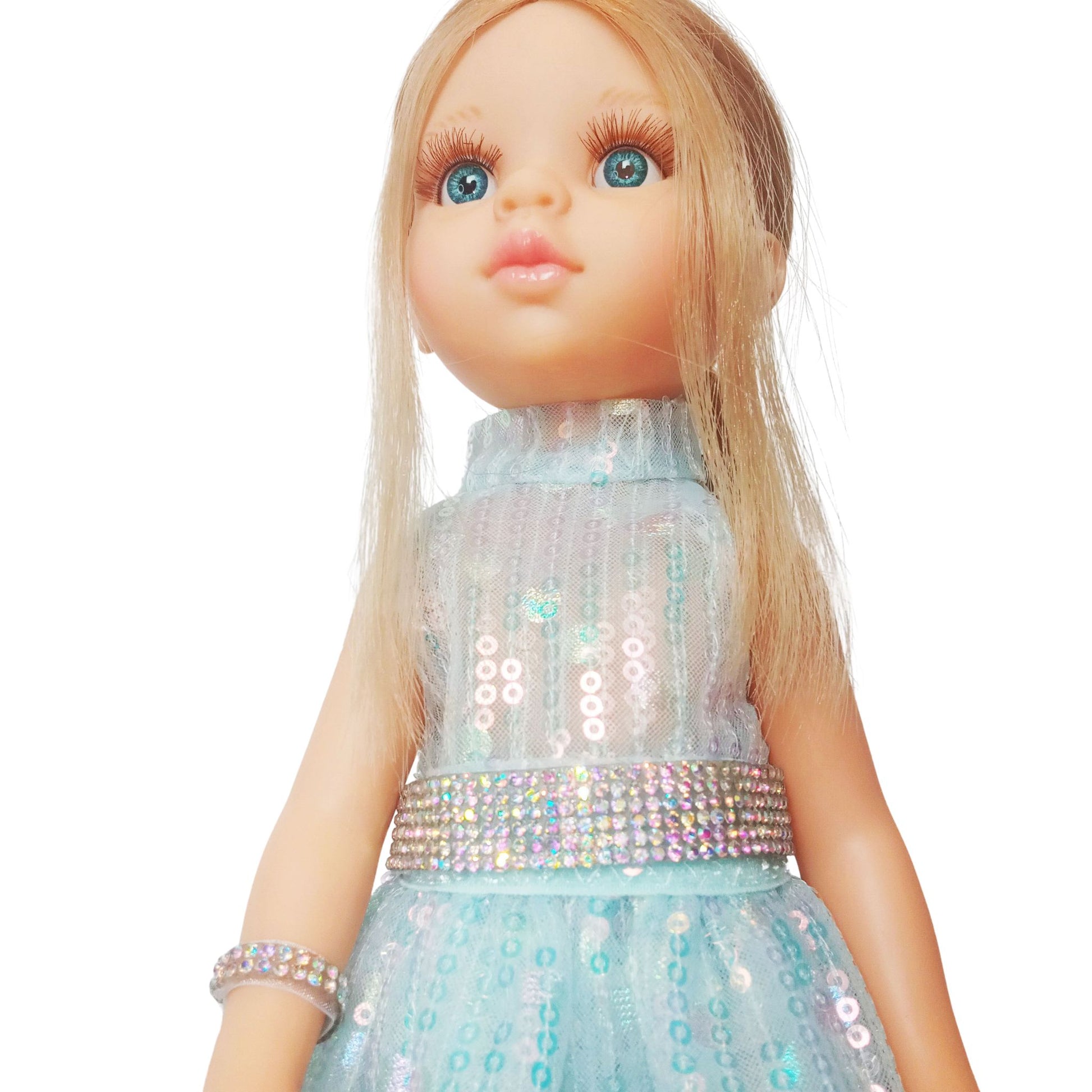 Paola Reina 32 cm doll in a shimmering sequin fairy dress with a sparkling belt and clutch  standing on a floor.