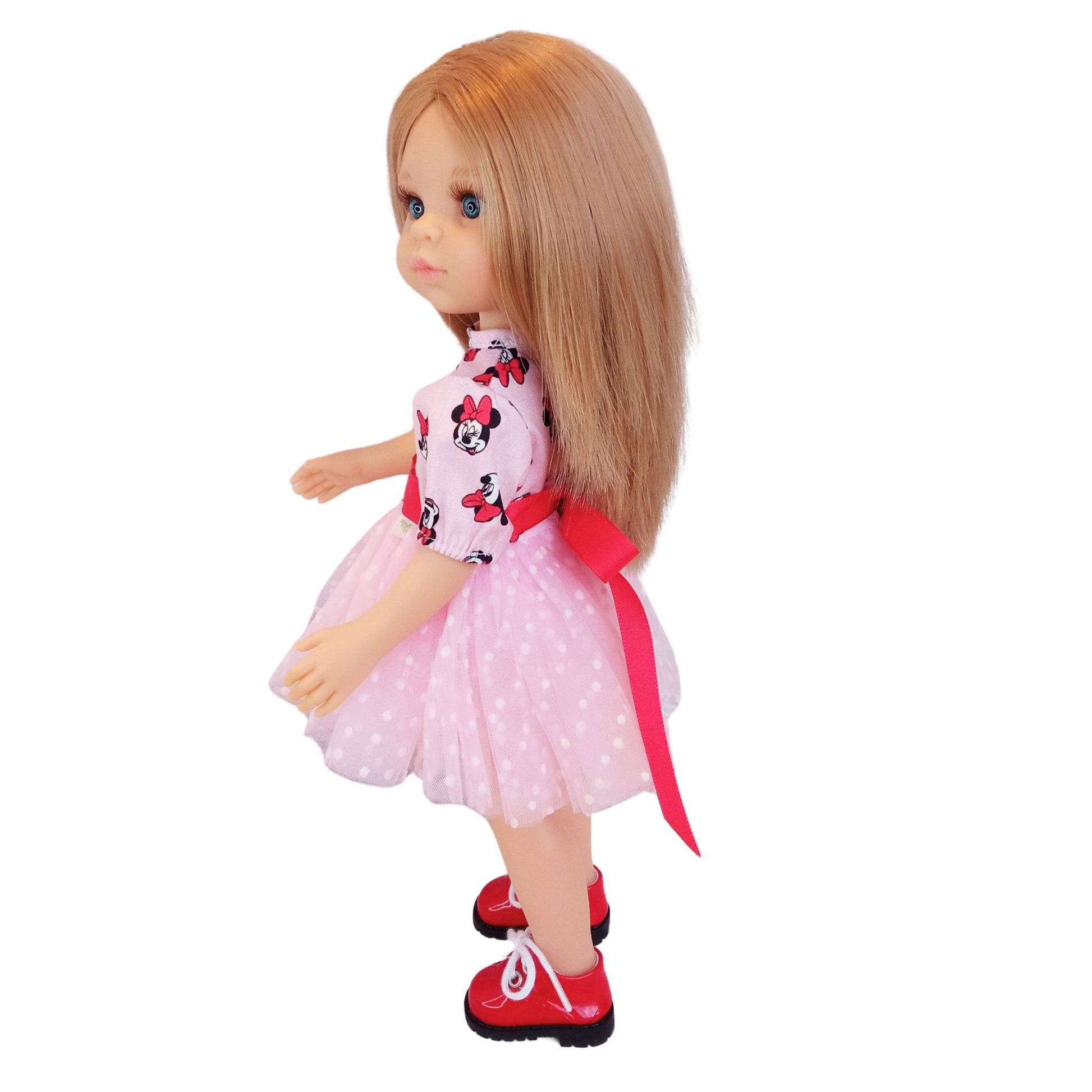 Paola Reina 32 cm doll wearing matching Minnie Mouse-inspired dresses with red satin bows and polka-dot mesh details. One doll has red shoes.