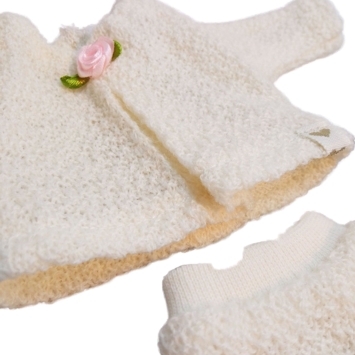 For Paola Reina Las Amigas 32 cm dollswearing handmade knitted jersey outfits with floral accents.