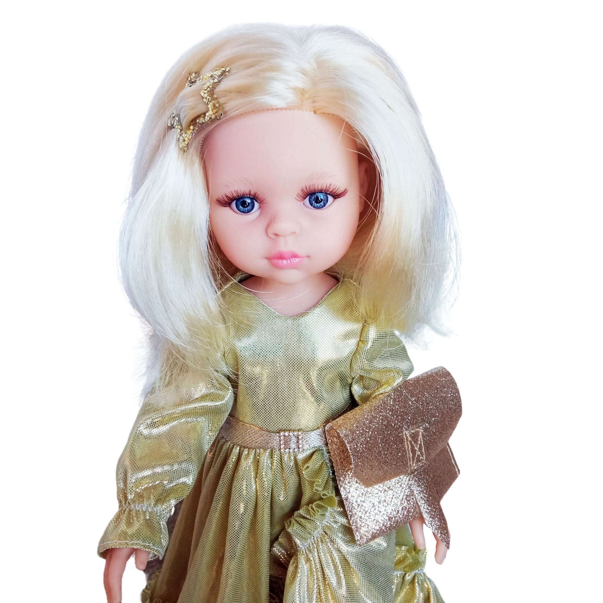 Paola Reina 32 cm doll Claudia dressed in an elegant shimmering gold gown with ruffles, holding a glittery clutch, and wearing stylish gold-trimmed shoes.