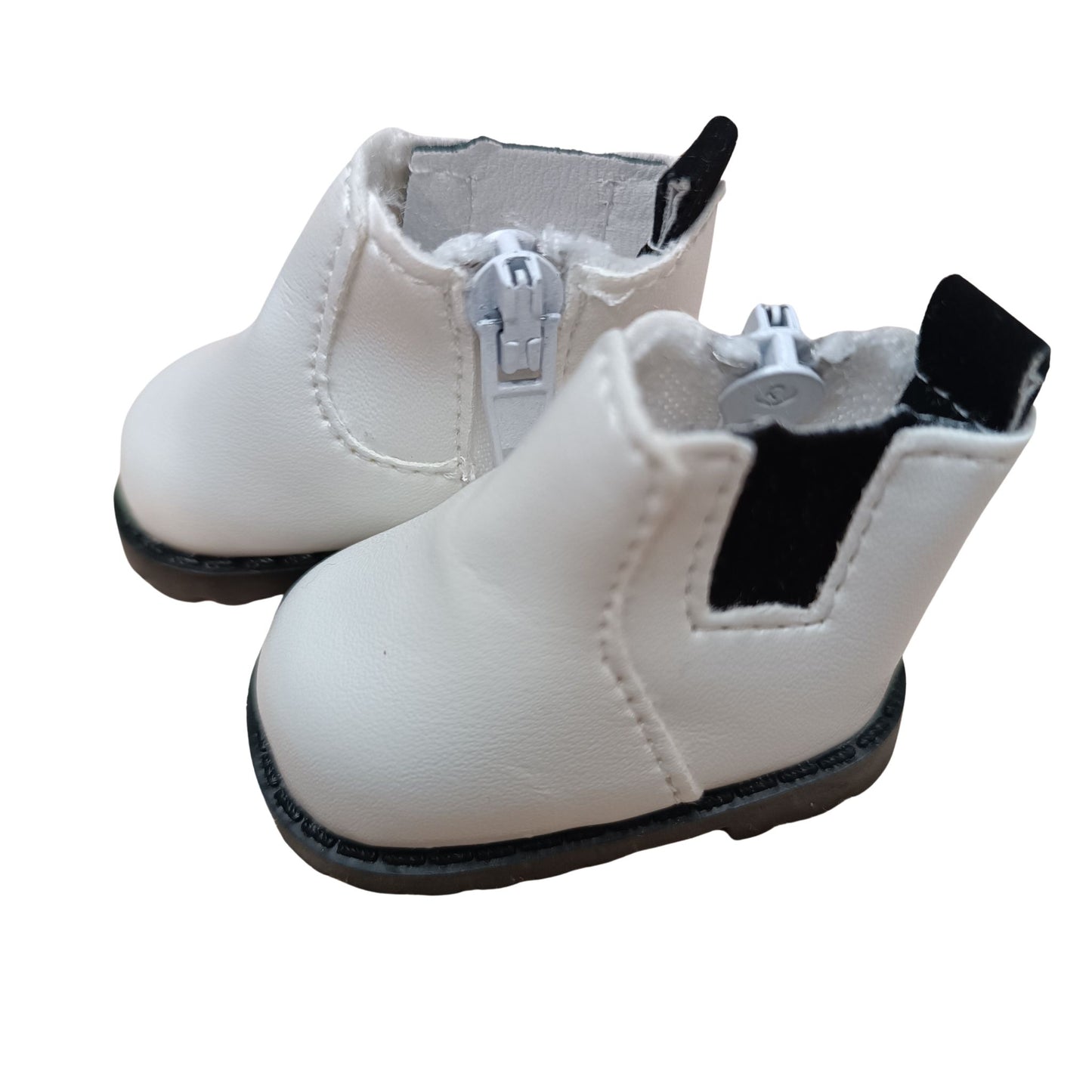 White Chelsea boots with black elastic accents and side zipper, designed for 32 cm Paola Reina dolls, featuring black rugged soles for a stylish and durable look.